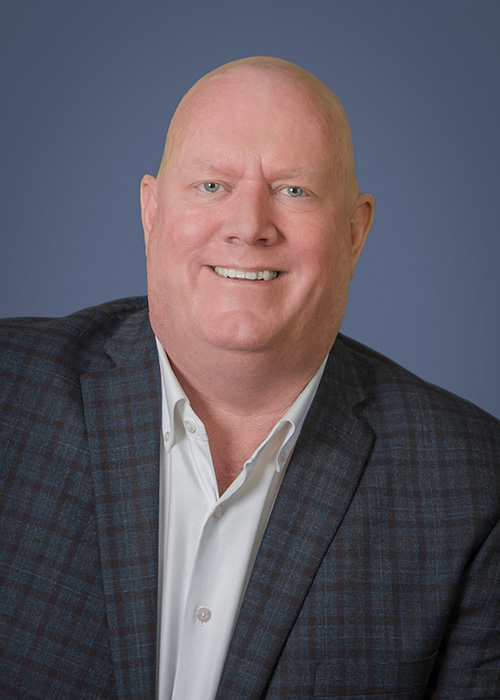Headshot of Bryan Maloney, owner of Maloney Services Group, in business attire